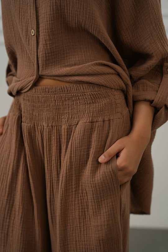 BROWN SMOCKED WAIST MUSLIN PANTS